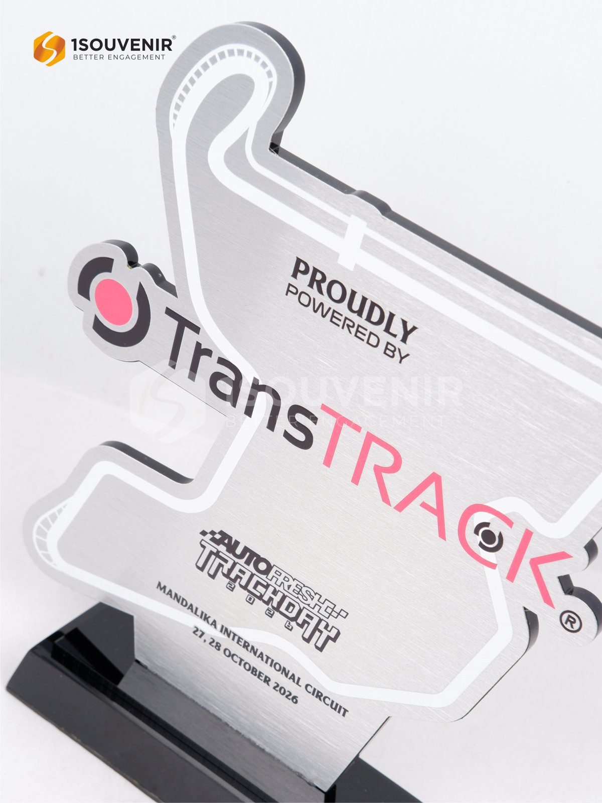 Detail desain plakat dengan logo TransTRACK dan tulisan PROUDLY POWERED BY