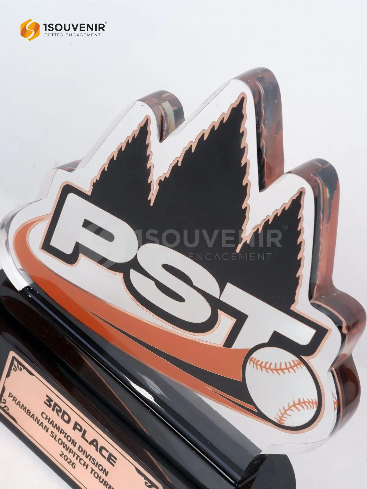 Detail panel transparan dengan grafis bola baseball putih dan pita oranye pada piala slowpitch